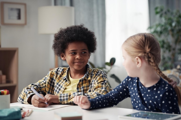 Children drawing together at table