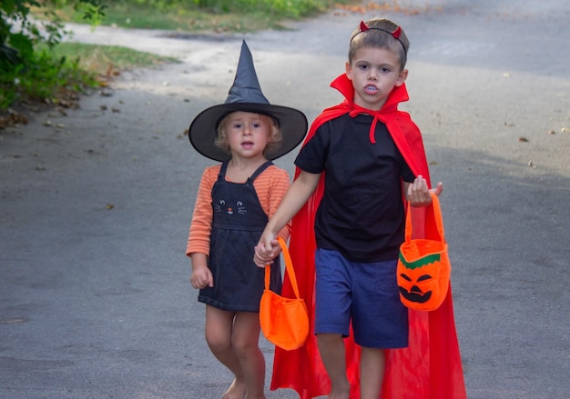 Children dressed in costumes for Halloween festive night Selective focus Halloween