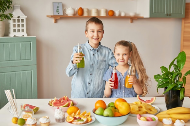 Children drinking juices at the kitchen