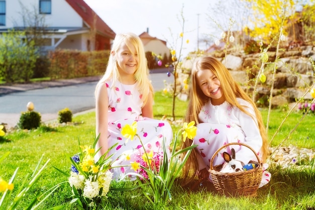 Children on Easter egg hunt with bunny