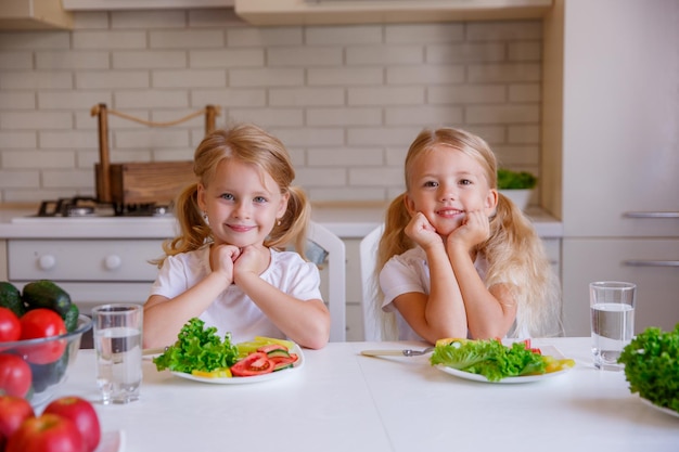 Children eat healthy food in the kitchen