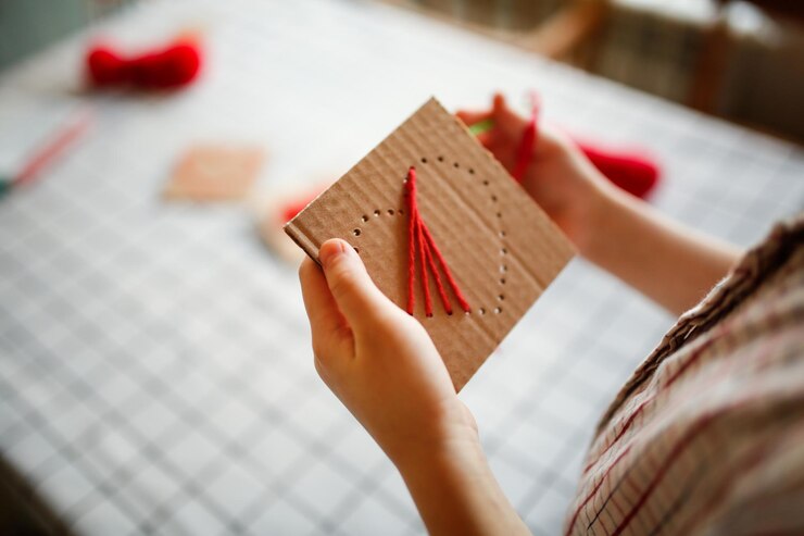 Photo children embroidered with shirts of hearts on cardboard