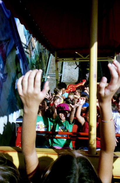 Photo children enjoying ride in amusement park