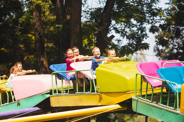 I bambini provano grandi emozioni di andare sulle montagne russe