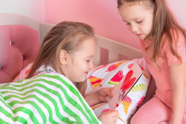 Children in the family congratulate each other on the Day of Love with homemade souvenirs