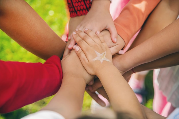 Photo children folded their hands together, play on the street