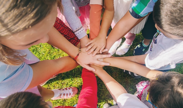 Photo children folded their hands together, play on the street