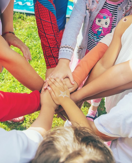 Children folded their hands together, play on the street