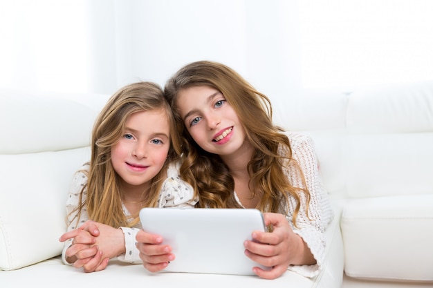 Children friends kid girls playing together with tablet pc