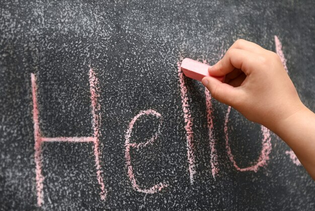 Children hand learn to write on the drawing board.