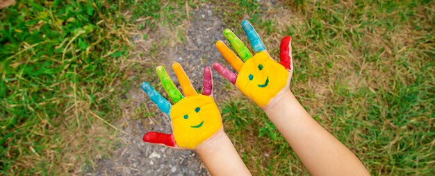 Children hands in colors. Summer photo. Selective focus.