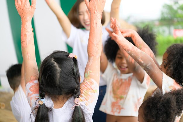 Children have fun playing with colors They are holding hands