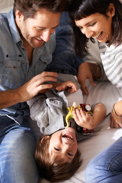 子供たちはあなたの生活に喜びを加える特別な方法を持っています家で息子と絆を結ぶ幸せな親のトリミングされたショット