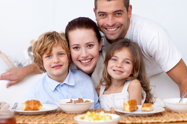 Children having breakfast with their parents