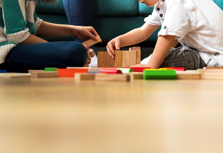 Photo children having fun playing toy blocks