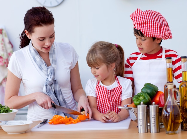 Children helping mother cooking in the kitchen