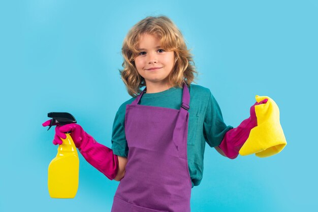 Children helping with housekeeping cleaning the house Housekeeping at home Cute child boy helping with housekeeping on blue studio backdround