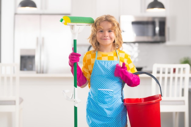 Children helping with housekeeping cleaning the house Housekeeping at home Cute child boy helping with housekeeping on kitchen interior backdround