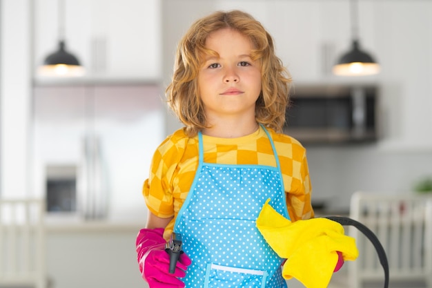 Children helping with housekeeping cleaning the house Housekeeping at home Cute child boy helping with housekeeping on kitchen interior backdround