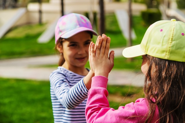 Children holding hands in the parkselective focus