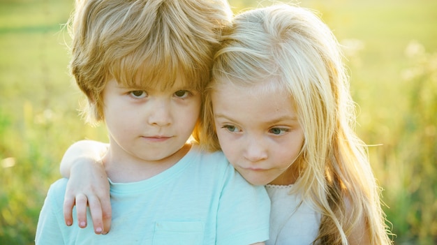 Children hugging for goodbye friendship and support bye bye little boy say good bye with little girl...