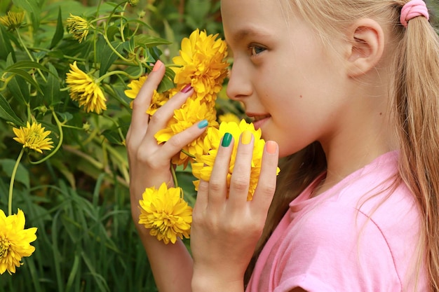 Children is multicolored manicure on a child with flowers