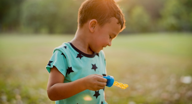 Children is playing bubbles in a park