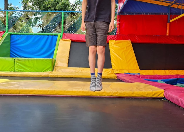 Children jumping on trampoline and having fun in park