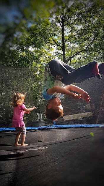 Children jumping on trampoline