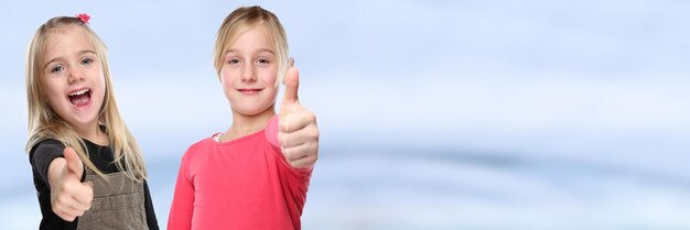 Photo children kids smiling young little girls success thumbs up copyspace copy space positive banner