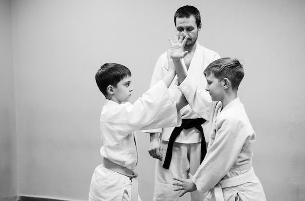 Children in kimono begin training on aikido.