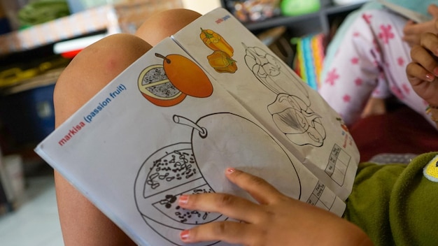 Children learn to color drawings at home