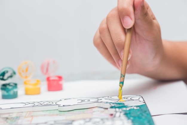 Children learn coloring and painting in classroom.