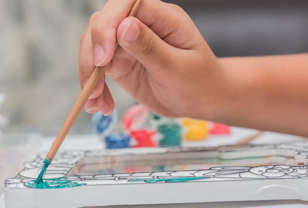 Children learn coloring and painting in classroom.