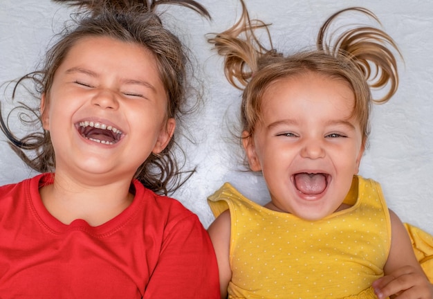 Children lie on the floor and laugh