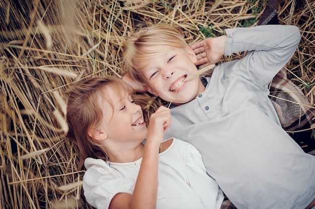 Children lie on the grass and play wheat field