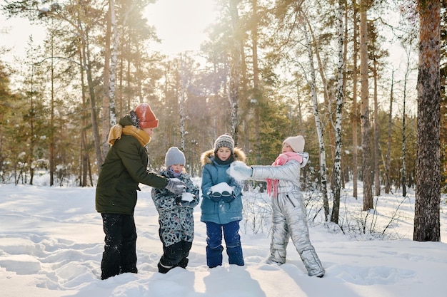 Children making snowman together