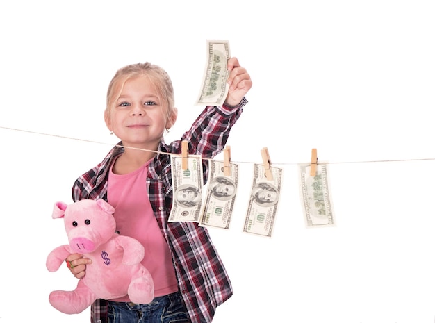 Children and money Girl with a piggy bank Girl hanging dollar bills on a rope isolated on white background