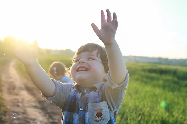 Children outdoors on nature in the grass field