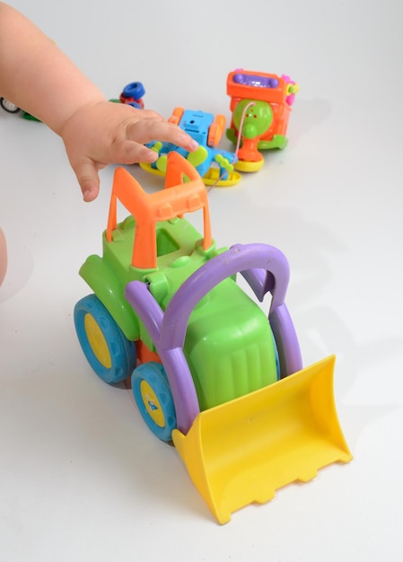 Children plaing with toy bulldozer on white background