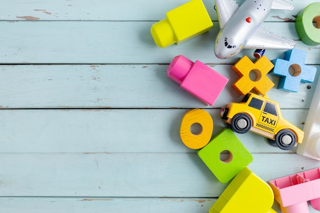 Children play background with toys on blue background. Top View.