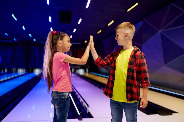 Children play bowling, game center, little bowlers