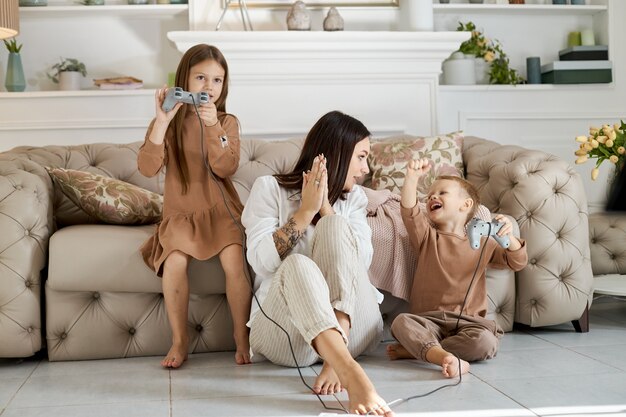 Children play on the console with their mother