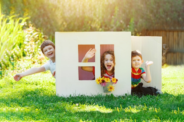 Children play in the house made of cardboard box