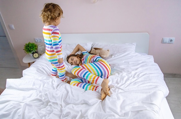 Children play jumping in bed Selective focus