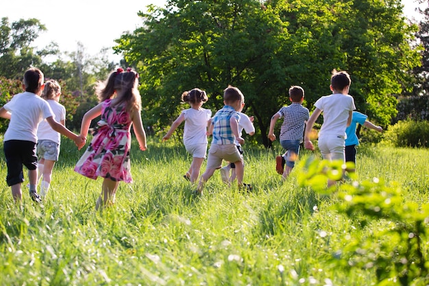 Children play outdoors running and having fun