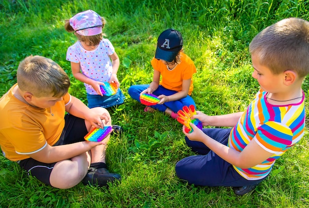 Children play pop it on the street