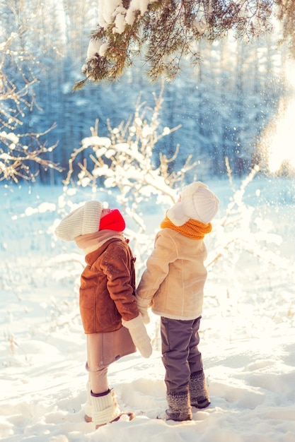 Дети играют в зимнем снежном лесу
