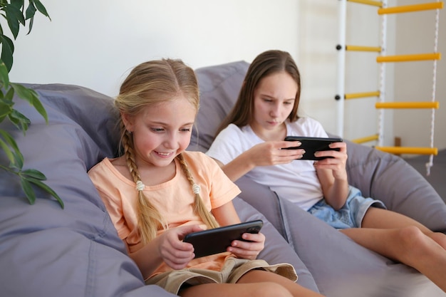 Children play with a mobile phone at home