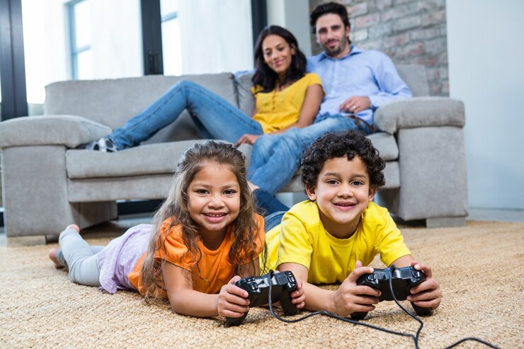 Children playing video games on the carpet in living room